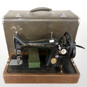 A Singer hand sewing machine in case