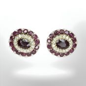 A pair of 14ct yellow gold ruby and diamond earrings featuring two oval cut rubies (1.