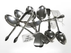 A pair of Georgian silver sugar tongs, Newcastle marks, a set of four silver dessert spoons,