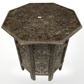 An Anglo-Indian heavily carved hardwood octagonal occasional table, height 55 cm.