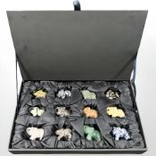A collection of twelve modern polished gemstone elephants, in fitted box.
