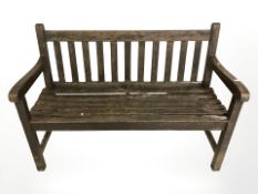 A stained teak garden bench,