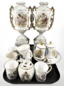 A pair of continental porcelain transfer printed twin handled urns on stands,