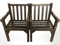 A pair of stained teak garden chairs,