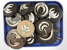 Eleven sets of wild boar tusks mounted on oak plaques.