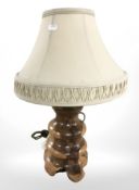 A turned wooden rustic table lamp, height 53 cm.