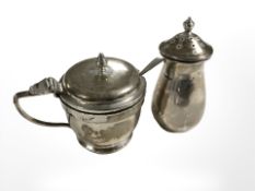 A silver salt with spoon and a further pepperette, height 7 cm.