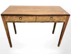 A contemporary Scandinavian teak two drawer side table with inset brass hoop handles,