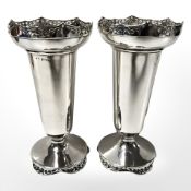 A pair of loaded silver bud vases, height 14.5 cm.