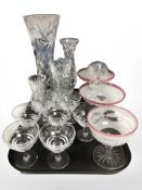 Four lead crystal vases, a group of etched champagne glasses, two tone pedestal bowls.