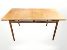 A G Plan teak pull out extending dining table with internal leaf,