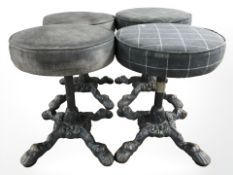 Four circular stools on cast iron supports.