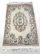 A Chinese floral rug, 207 cm x 122 cm.