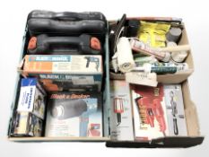 A group of boxed power tools including Black and Decker, hand drill, inspection lamp,