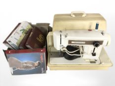 A Frister Rosmann sewing machine with lead and pedal plus several folders of sewing patterns