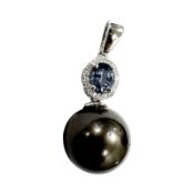 A 14ct white gold pearl, sapphire and diamond pendant, the oval-cut sapphire weighing 0.