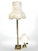 A brass Corinthian column standard lamp and a similar table lamp.