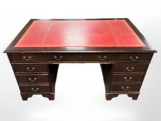 A reproduction mahogany twin pedestal writing desk, fitted nine drawers, 152 cm x 90 cm x 79 cm.