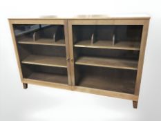 A contemporary glazed double door bookcase,