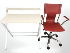 A red stitched vinyl and chrome swivel desk chair and folding office table