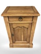 A contemporary oak bedside cupboard,