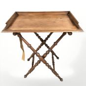 A walnut X-framed table, with tray top, 79 cm.