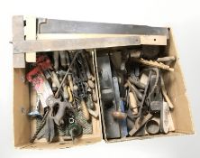 Assorted vintage carpentry tools including planes, hand drill, saw, chisels, etc.