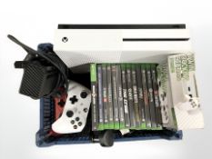 An Xbox One console, controllers and various games.