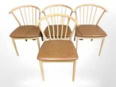 A set of four Danish oak spindle back elbow chairs, with tan vinyl seats.