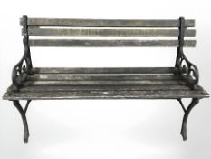 A cast iron and teak garden bench,