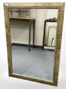 A contemporary bevelled mirror in a scumbled finish, 73 cm x 105 cm.