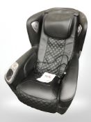 A black vinyl massage chair.