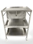 A stainless steel catering trolley and an aluminium footstool