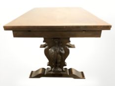 A continental carved oak draw leaf extending refectory dining table,