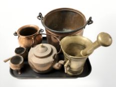 A brass mortar and pestle, copper swing handled pots, tea pot, etc.