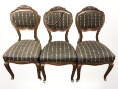A set of three mahogany dining chairs on cabriole legs.