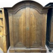 A 19th century Continental oak dome topped double door cabinet,