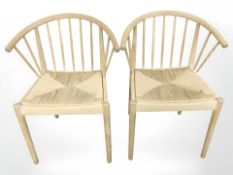 A pair of Scandinavian spindle back elbow chairs with rush seats.