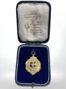 A 9ct yellow gold and enamel presented for services rendered European war 1914 - 1918,