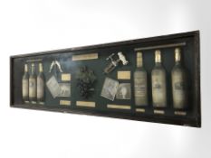 A reproduction wine montage in glazed display case,