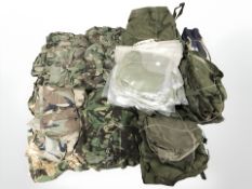A large quantity of military surplus clothing, canvas bags, etc.