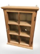 A reproduction pine single door wall cabinet, width 56 cm.