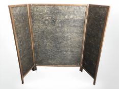 A mahogany and embossed paper three fold screen, largest panel 96 cm x 134 cm.