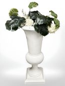 A large white plastic urn containing artificial flowers, height 122 cm.