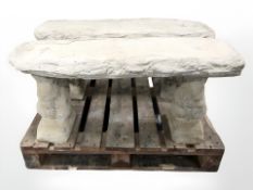 A concrete garden bench on squirrel supports,