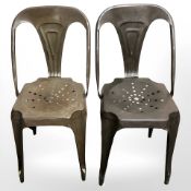A pair of sheet metal cafe chairs