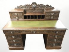 A Victorian heavily carved oak twin pedestal writing desk,