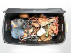 A plastic chest with snap-on lid containing various ratchet straps, jump leads, spray gun, etc.