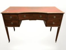 A late Victorian mahogany and satinwood strung inverted bow front writing desk,