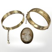 Two 9ct rolled gold bangles together with an antique cameo brooch (3)